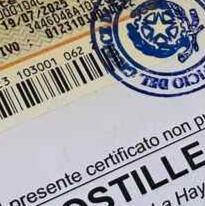 A close-up of an English to Italian sworn translation, or "traduzione giurata," with an apostille and an Italian revenue stamp.