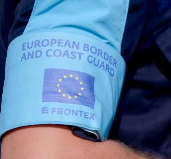 A European border and coast guard officer checking visas for entry in Italy.