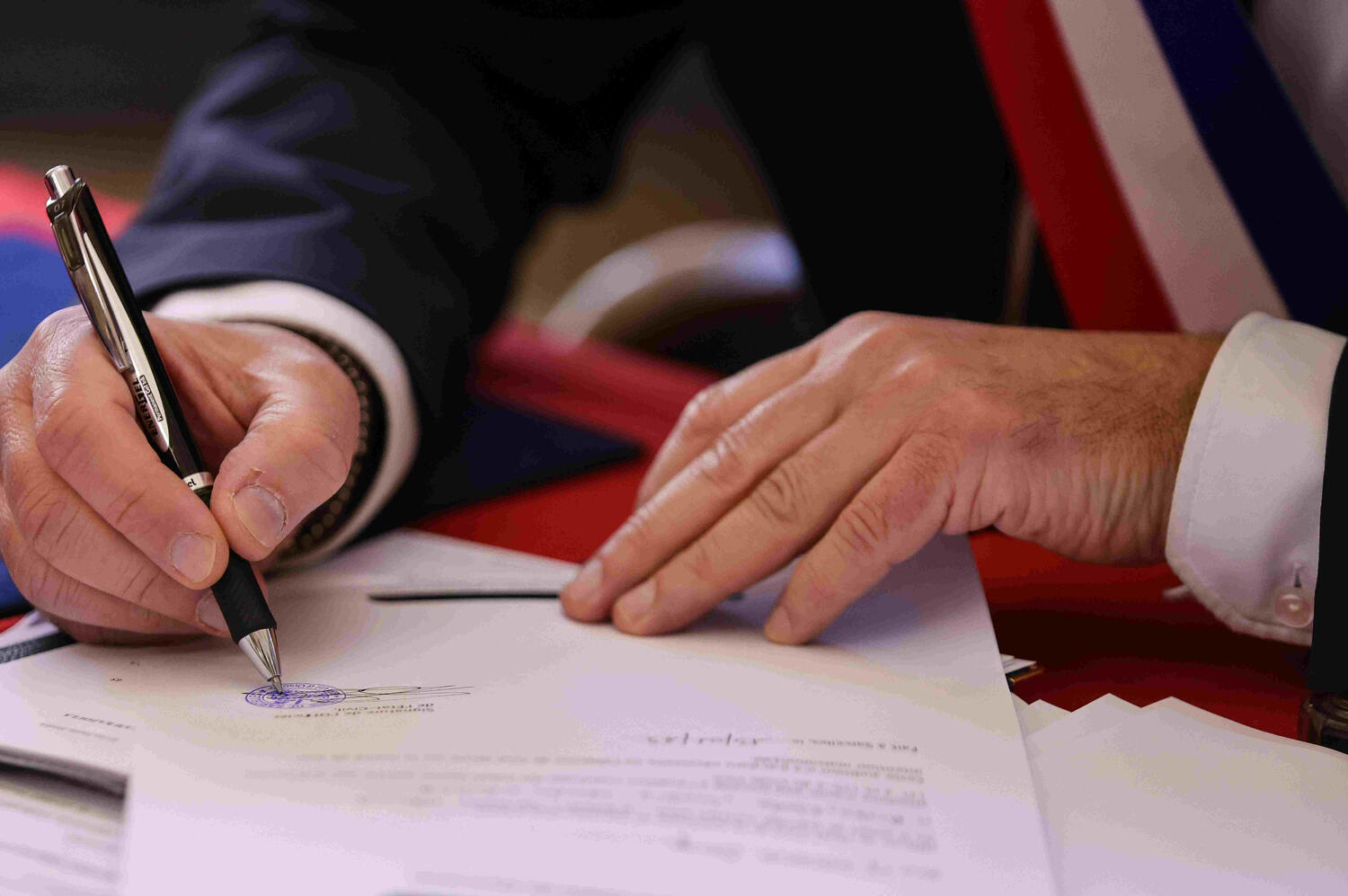 An Italian court official is signing and sealing an English to Italian sworn translation in Tuscany, Italy.